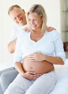 Pregnant woman holding stomach